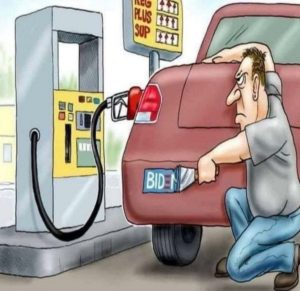 man scraping biden stucker off bumper at gas pump