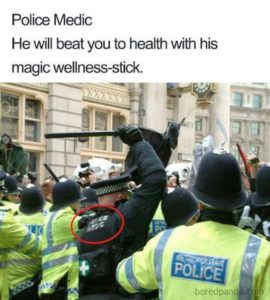 police medic with raised baton