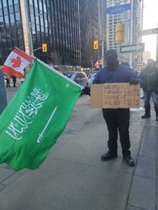 muslim holding anti trudeau sign