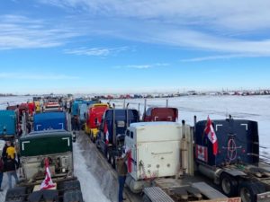 truck convoy on highway stretching into the horizon