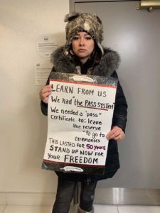 first nation girl holding sign loss of freedom canada protest